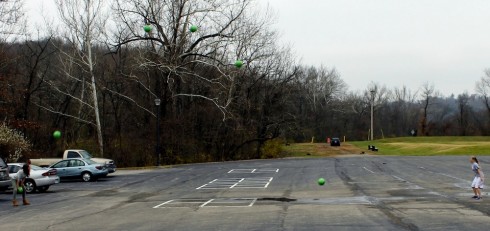 Layered image showing the ballistic path of the green ball thrown by two middle school students. Image by Michael Schmidt.