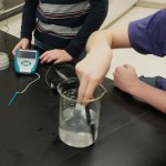Students measure the conductivity of a salt water solution.