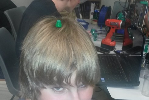 Student models a "fez" he modelled in OpenSCAD. This was the first object, other than the test cube, that was printed on our 3d printer.
