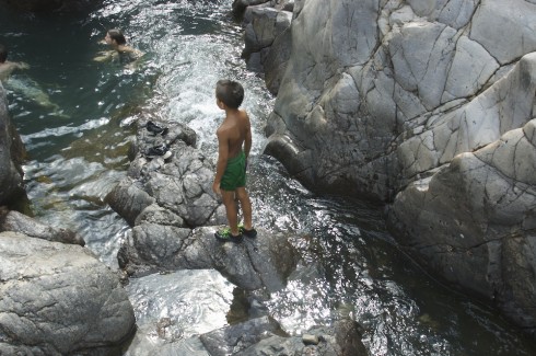 Rushing water in a shallow channel leads to a deeper pool.