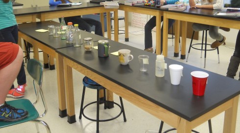 Students study the twelve different containers, using reason to deduce their thermal properties.