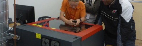 Students etching an anodized aluminum luggage tag during their SBU class on the laser cutter/etcher. 